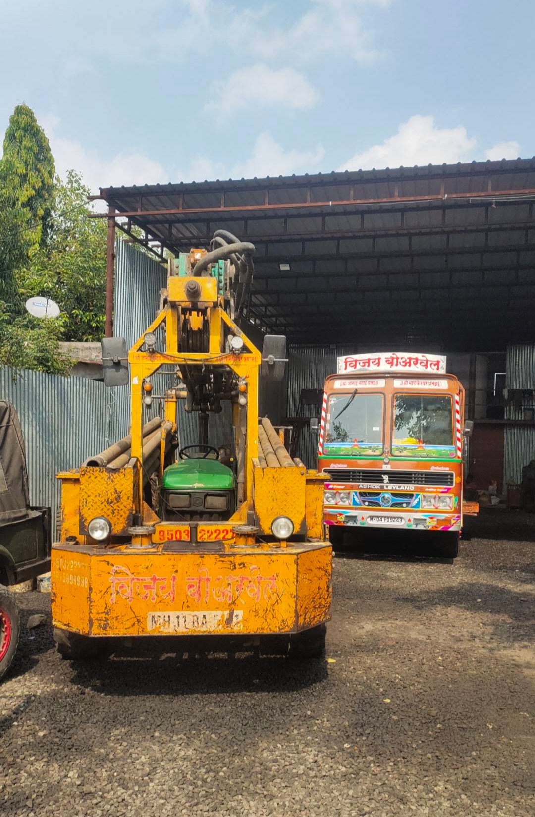 Vijay Borwell tractor-mounted rig and drilling truck parked at the yard